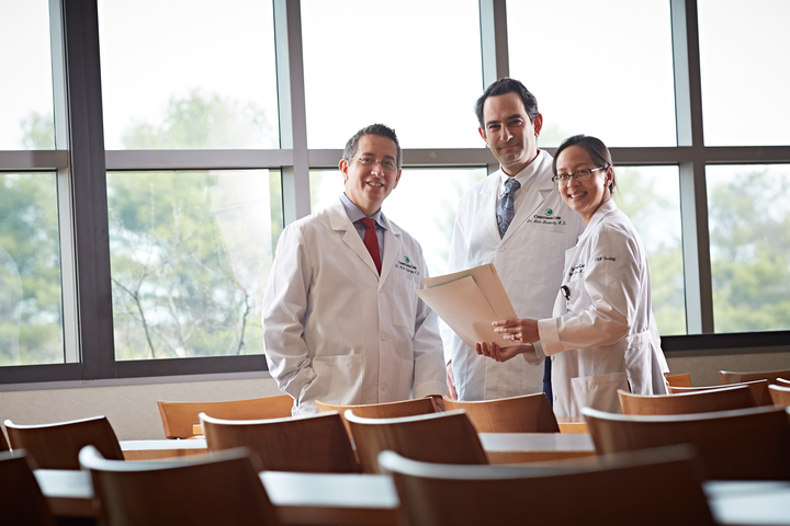 Providers gathered around a research document